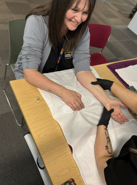 Kerry Renwick, one of our admissions team, getting a hand massage from one of our beauty students!